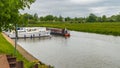 Boats of differing types and sizes line the banks of the River Great Ouse in Ely