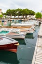 Boats on the dock, bridge and olives. Garda. Italy.