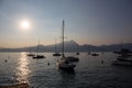 Boats docked in the Garda Lake at sunset, in the Torri Del Benaco town port; almost sunset, beautiful light Royalty Free Stock Photo