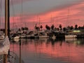 boats docked on the harbor as the sun set over the sea Royalty Free Stock Photo