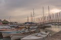 Boats docked in a harbor under the sunset sky Royalty Free Stock Photo