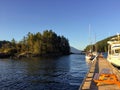 Boats docked on a peaceful evening on Alexander Island, which is in West Bay, Gambier Island, Howe Sound, British Columbia, Canada