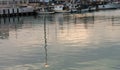 Boats docked and reflections in the water in the evening Royalty Free Stock Photo