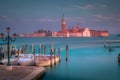 Boats docked by wooden mooring poles in grand canal, Ethereal Venice, Italy Royalty Free Stock Photo