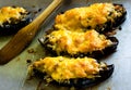 Boats of eggplant zucchini stuffed with meat, rice, tomato and mushrooms with grated cheese