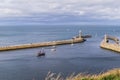 Boats entering and leaving the harbour at Whitby Royalty Free Stock Photo