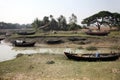 Boats of fishermen stranded in the mud at low tide on the coast of Bay of Bengal