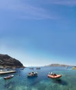 Boats at the fishing harbour village of Oia and Amoudi Bay in Santorini greek island clear meditoraiian clear blue waters and sky Royalty Free Stock Photo