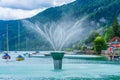 Boats and fountain on Wolfgangsee lake in Sankt Gilgen, Austria Royalty Free Stock Photo