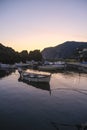 boats in the harbor of Framura, Liguria, Italy during sunset sky across cliffs Royalty Free Stock Photo