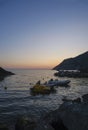 boats in the harbor of Framura, Liguria, Italy during sunset sky across cliffs Royalty Free Stock Photo