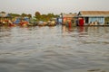 Boats and houses in gloating fishing village of Tonle Sap River in Cambodia