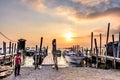 Boats, jetties & volcano in golden hour, Lake Atitlan, Guatemala Royalty Free Stock Photo