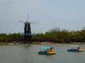 Boats on a lake at in front of windmill Shanghai flower port Royalty Free Stock Photo