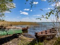 Boats on the lakeshore, nature landscape photography, sunny day with blue sky, Wigry lake and monastery
