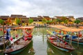 Boats with lampions on canal in tourist destination Hoi An, Vietnamese women in Hoi An, Vietnam