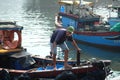 Boats and Lifestyle at Qui Nhon Fish Port, Vietnam in the morning. Royalty Free Stock Photo