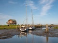 Boats at low tide in harbour of Halligen Hooge, North Frisia, Schleswig-Holstein, Germany