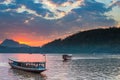 Boats on Mekong River at Luang Prabang Laos, sunset dramatic sky, famous travel destination backpacker in South East Asia Royalty Free Stock Photo