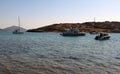 Boats moored in dark Mediterranean sea waters of the strait between Gorecek Adasi Island and the mainland.