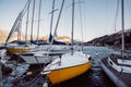 Boats moored in the harbor in Italy on the surface of the lake Lago di Garda during the sunrise