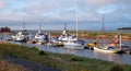 Boats moored at the quay at Morston near Holt on the North Norfolk coast, East Anglia UK. Photographed at sundown.