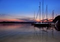 Boats moored by the shore at sunset.