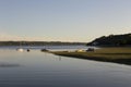 Boats moored in the St. Lawrence River and back view of man on paddle board in the Cap-Rouge bay area of Quebec City Royalty Free Stock Photo