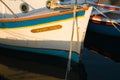 Boats moored to dock posts with ropes in a harbor in Paroikia, Greece Royalty Free Stock Photo