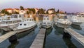 Boats moored to three parallel docks