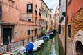 Narrow canal surrounded by old decaying buildings in Venice