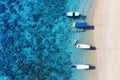 Boats near the beach. Seascape from drone. Blue water background from top view. Gili Meno island, Indonesia.