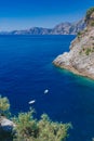 Boats over blue water and coastline near the town of Praiano, along the Amalfi Coast, Italy Royalty Free Stock Photo