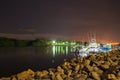 Boats parked at marina at night