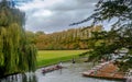 Boats parked in a row and people enjoying punting on river Cam during summer at Cambridge Royalty Free Stock Photo