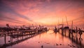 boats parked on a sandy beach at sunset