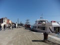 Boats and people coexisting in the touristic scenery of the city of Venice