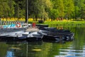 Boats on the pier in the city Park. Summer Park with a lake. Docked wooden rowing boat. Royalty Free Stock Photo