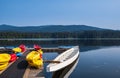 Boats at the pier on the forest lake in Canada. Boats docked at the lake in a summer morning Royalty Free Stock Photo