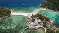 Boats and pier near small islands. Motor dive boats floating on calm blue sea near unique small islets connected with beaches and