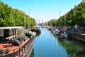 Boats in Port of Copenhagen, Nyhavn Historical Pier Port and Canal with Green Trees Along the Banks in Denmark.