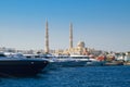 Boats in port next to the fishing market and Central Mosque on the background Royalty Free Stock Photo