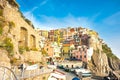 Boats pulled up below steep colored hillside village buildings b Royalty Free Stock Photo