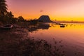 Boats and a quiet ocean at bright sunset time. Le Morn mountain in Mauritius Royalty Free Stock Photo