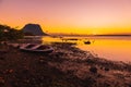 Boats and quiet ocean at sunset time. Le Morn mountain in Mauritius Royalty Free Stock Photo