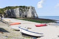 Boats on resort beach and view of cliff in Etretat
