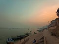 Boats at river Ganga Ghat people at holy ghats among ancient hindu temples in early morning in Varanasi Evening at Banaras Ghat