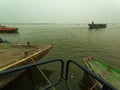 Boats at river Ganga Ghat people at holy ghats among ancient hindu temples in early morning in Varanasi Evening at Banaras Ghat