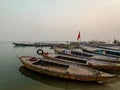 Boats at river Ganga Ghat people at holy ghats among ancient hindu temples in early morning in Varanasi Evening at Banaras Ghat