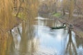 Boats on the river among leafless trees on a cloudy autumn day. Autumn Royalty Free Stock Photo